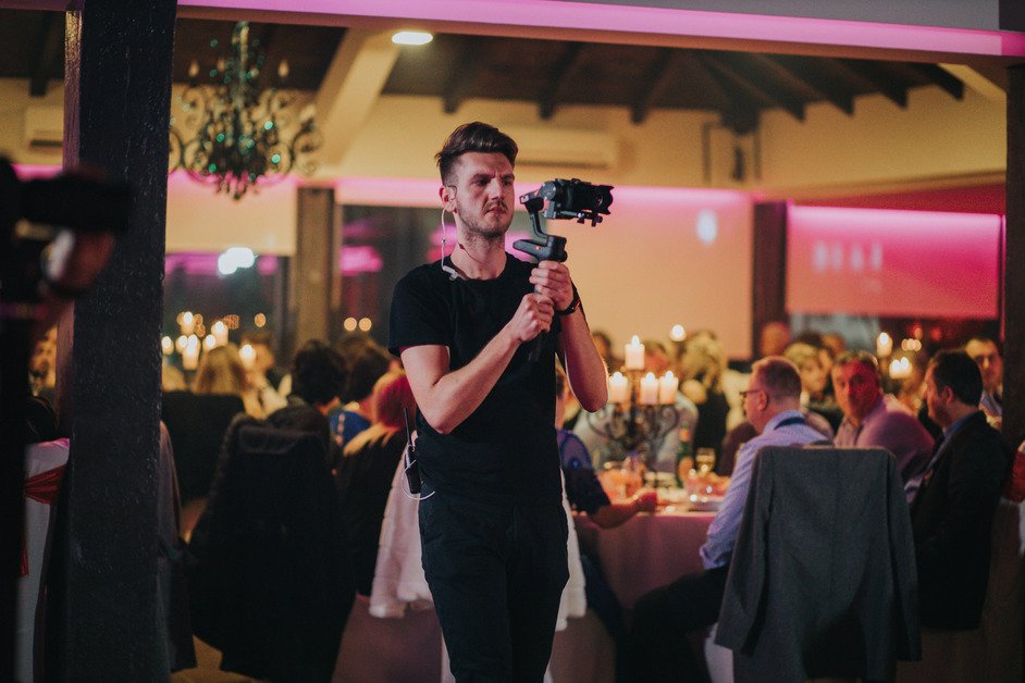 shallow-focus-young-cameraman-filming-wedding-celebration-restaurant
