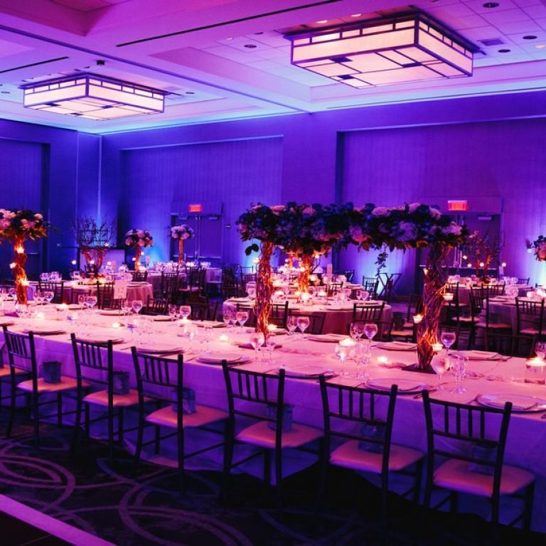 Decorated banquet hall with flowers, rectangle table, chiavari c