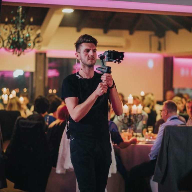 shallow-focus-young-cameraman-filming-wedding-celebration-restaurant